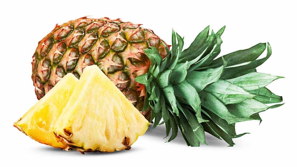 a whole pineapple and two pineapple slices