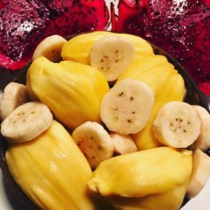 bowl of durian fruit, bananas, and dragon fruit