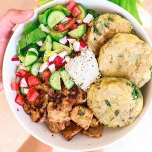 bowl with veggies, chicken and potato cakes