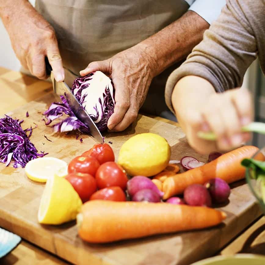 Couple chopping vegetables