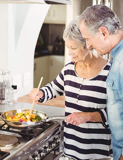 Elderly couple cooking food